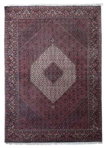 An Oriental woollen rug, decorated with geometrica…