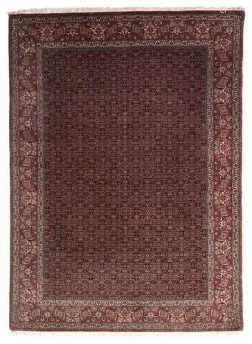 An Oriental woollen rug with floral motifs, 204 x …