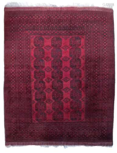 An Oriental woollen rug, decorated with stylised m…