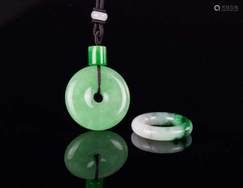 A Translation Green Jadeite Circular Pendant And