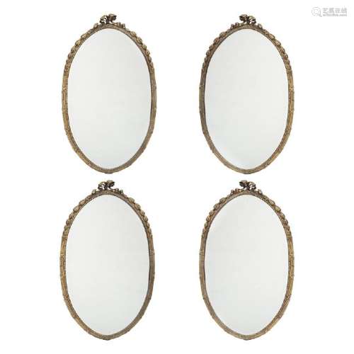Set of four oval and bevelled mirrors with gilt bronze