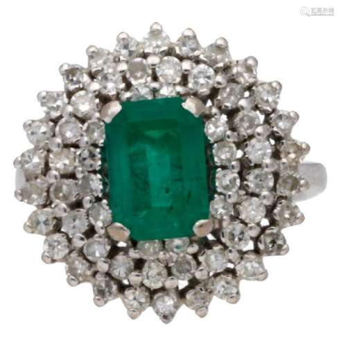 Emerald ring with diamonds border, circa 1950.