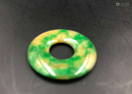 A RING-SHAPED JADEITE PENDANT