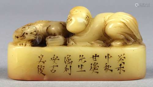 Chinese soapstone seal, the tan colored matrix carved with a child nestled beside a mythical