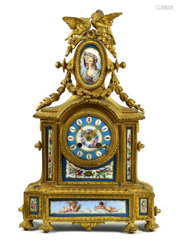 French ormolu mounted clock, having a figural finial depicting birds, surmounting a Sevres style