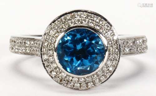 Blue topaz, diamond and 18k white gold ring Centering (1) round-cut blue topaz, weighing