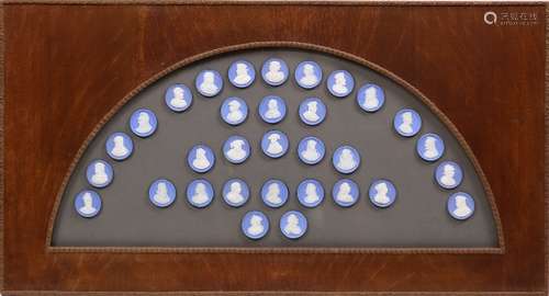 Framed group of 32 Wedgwood jasperware medallions, each depicting British royalty, overall 17.5