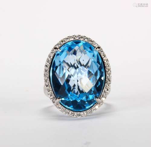 Blue topaz, diamond and 14k white gold ring Featuring (1) oval faceted top blue topaz, weighing