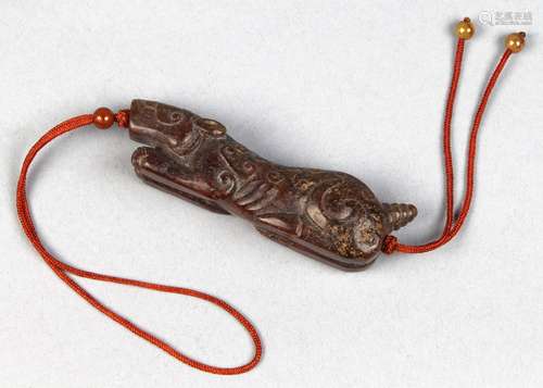 Chinese archaistic hardstone toggle, in the form of a recumbent tiger with scroll pattern carved