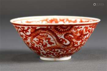 Chinese iron red decorated porcelain bowl, interior with a child amid lotus scrolls painted in red