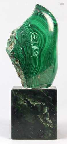 Polished malachite cartouche, etched with Egyptian hieroglyphics, the whole rising on a jadeite