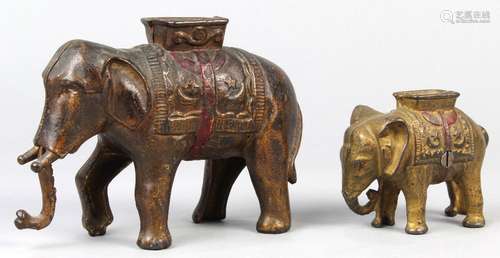 (lot of 2) Cast iron elephant penny/still banks, each depicted with a howdah, one retains original