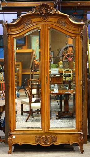 Louis XV style walnut armoire, having a rocaille crest centered with a figural medallion, above