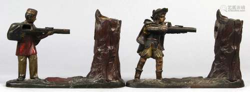 (lot of 2) Cast iron mechanical penny banks, comprising one depicting a soldier attired in a red