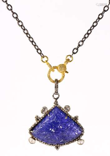 Tanzanite, diamond and silver pendant-necklace Featuring (1) carved tanzanite, measuring