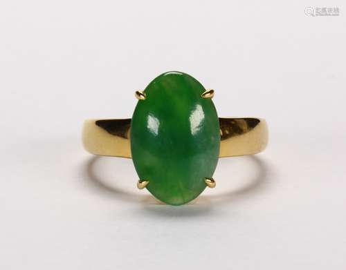 Jadeite and 14k yellow gold ring Featuring (1) green jadeite cabochon, measuring approximately 9.