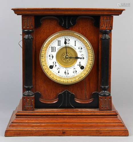 Victorian mantle clock, by Fattorini & Sons Bradford, a wooden case framing the round enamel dial