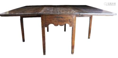 English oak drop leaf table, having a rectanglar top, above a shaped apron and rising on square