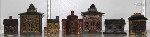 lot of 7) Cast iron still/penny banks, each in the form of a building or bank, some retain