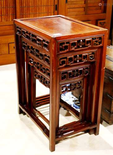 Set of four Chinese nesting tables, each with a floating top panel, the apron reticulated with