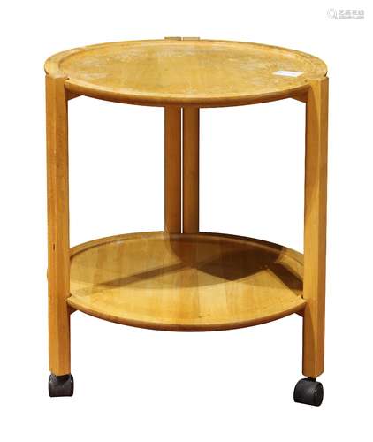 Mid Century tiered occasional table, having a circular top and rising on contoured legs conjoined by