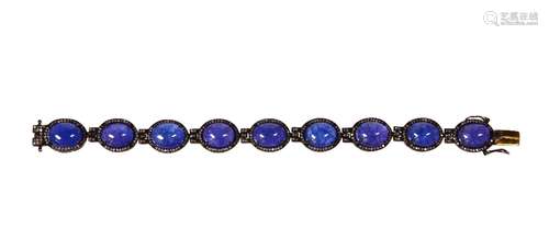 Tanzanite, silver and 14k yellow gold bracelet Featuring (9) oval tanzanite cabochons, measuring