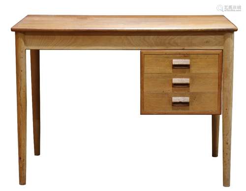 Mid-Century Modern desk, having a rectangular top, above three drawers, and rising on a tapered