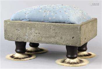 Folk Art foot stool, havig an embroidered cushion, cement frame, and rising on four shaving