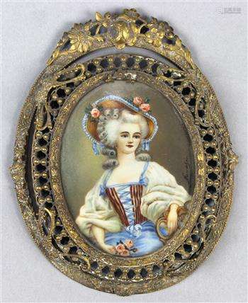 Rococo style miniature framed portrait, the oval gilt metal frame adorned with a foliate and foliage