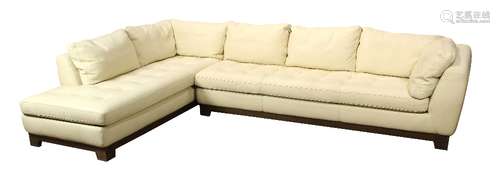 Roche Bobois sectional sofa, executed in cream italian leather, having a wood seat rail, and