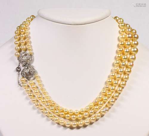 Cultured pearl, diamond and platinum triple-strand necklace Composed of numerous graduating cultured