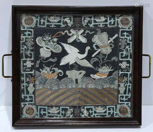 Chinese rank badge set into a tray, embroidered with a crane amid Daoist treasures on a blue ground,