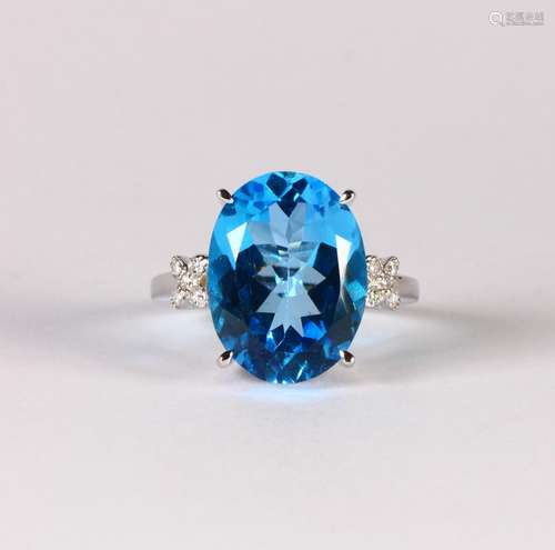 Blue topaz, diamond and 14k white gold ring Featuring (1) oval-cut blue topaz, weighing