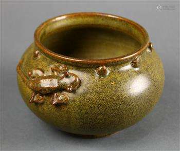 Chinese green glazed ceramic jar, with a rolled rim above a band of bosses, the shoulder of the