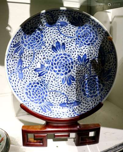 Chinese underglaze blue porcelain charger, featuring tendrils issuing large blossoms on a dense