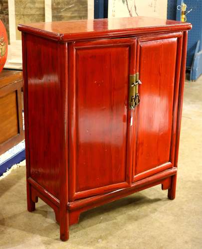 Chinese red lacquered cabinet, fronted by a pair of hinged double doors, concealing shelves and a