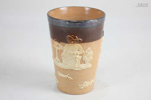 A Doulton Lambeth silver mounted stoneware beaker decorated in raised relief with countryside scenes