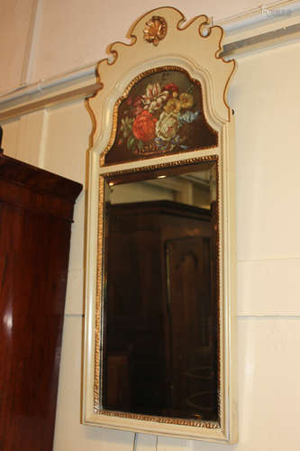 A Georgian style painted wall mirror with scroll carved arched surmount painted with a basket of