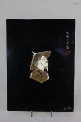 A Japanese black lacquered panel with bone and horn inlaid profile of a Vietnamese man, signed, with