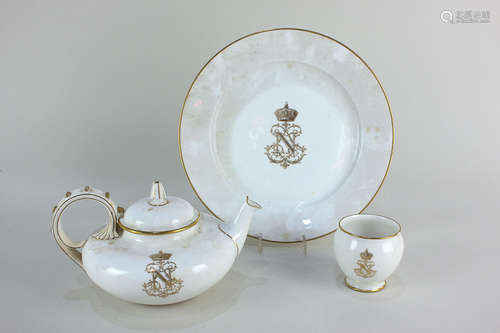 A 19th century Sevres porcelain teapot, plate and small bowl, all bearing the monogram of Napoleon