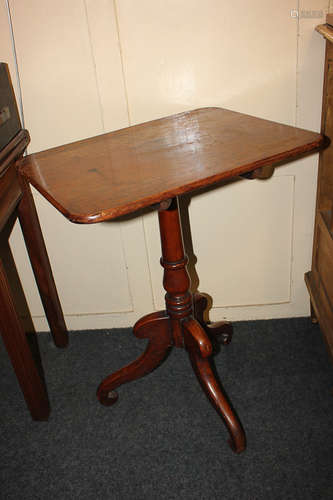 A 19th century mahogany tilt top table, with rectangular shaped top on turned stem and outswept