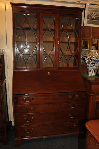 A George III mahogany bureau bookcase with associated line inlaid panel glazed top with two doors