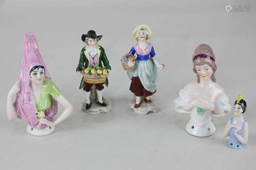 Three porcelain half dolls to include a figure wearing a pink headdress, 10cm, together with a