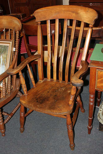 A farmhouse kitchen chair with scroll arms, on turned legs