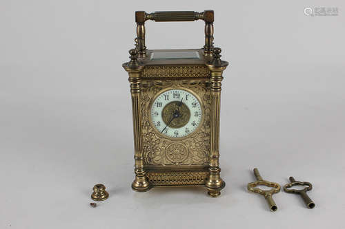 A French carriage clock with enamel chapter ring and gilt scroll face, with fluted column