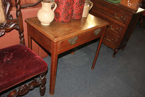 An oak side table, with rectangular top and single drawer with pierced back plates and brass drop