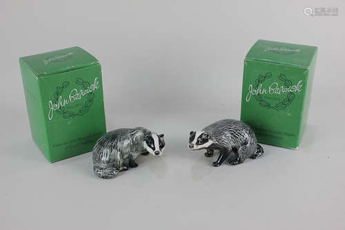 Two Beswick models of a male and female badger, in black and white gloss, 5cm, both with tissue