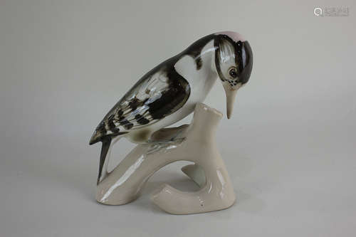 A Royal Dux porcelain model of a woodpecker perched on a branch, 18cm