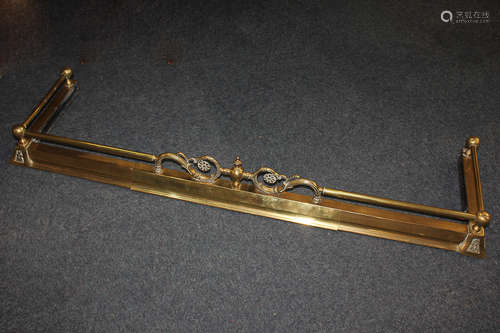 A brass ball and rail pattern fire fender, with central scrolling pierced decoration, 132cm