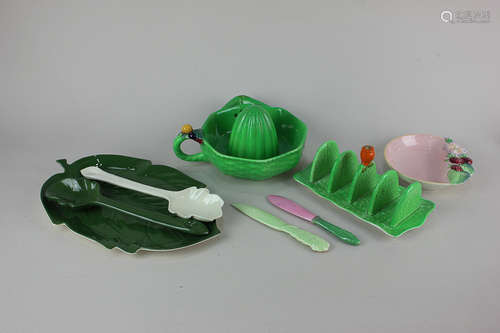 A collection of Carlton ware pottery comprising green glazed citrus squeezer, toast rack, leaf